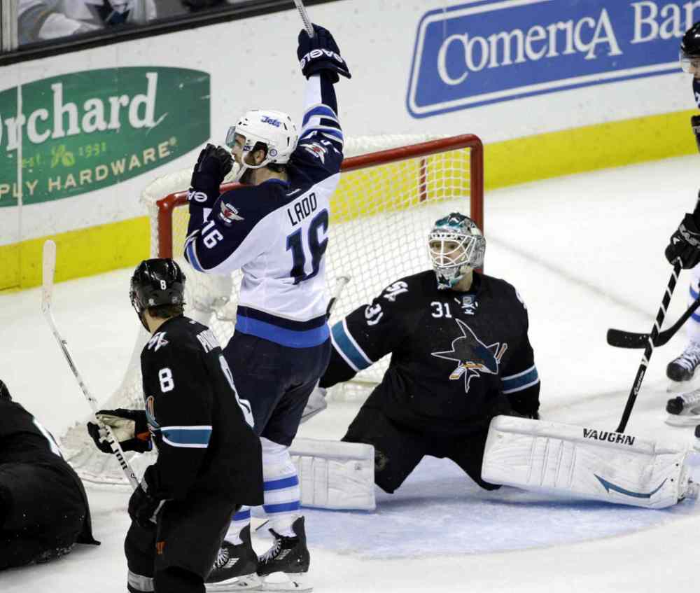 Marcio Jose Sanchez / The Associated Press
Winnipeg Jets' Andrew Ladd (16) celebrates a goal by teammate Tobias Enstrom, next to San Jose Sharks goalie Antti Niemi (31), during the third period.