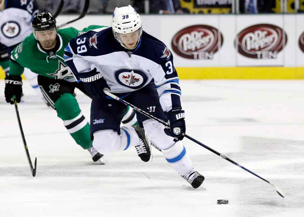 Tony Gutierrez / The Associated Press
Winnipeg Jets defenceman Tobias Enstrom controls the puck as Dallas Stars forward Vernon Fiddler (gives chase in the first period.