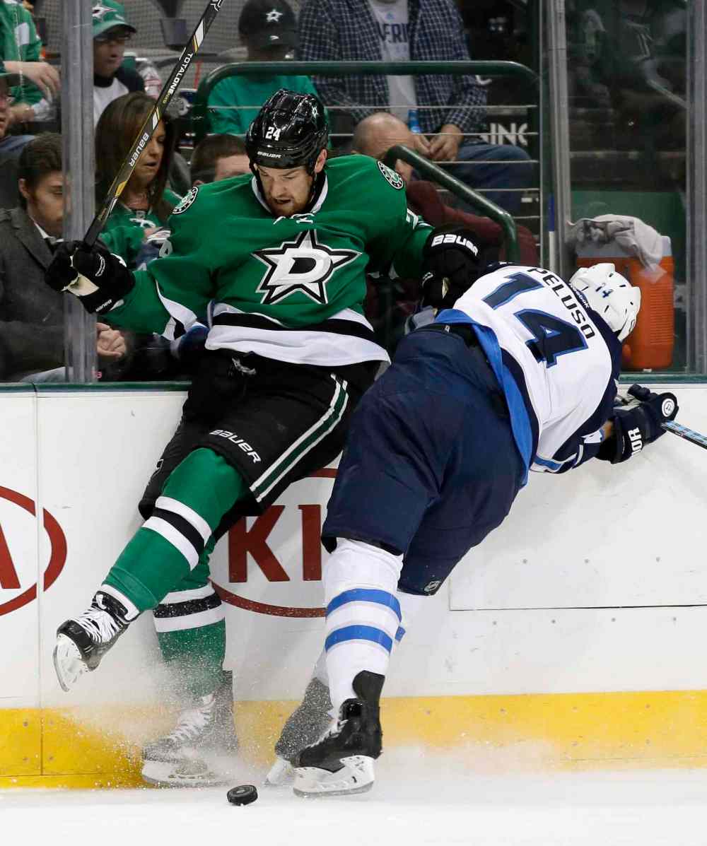 Tony Gutierrez / The Associated Press
Dallas Stars defenceman Jordie Benn (left) and Winnipeg Jets winger Anthony Peluso collide as they race for a loose puck in the second period.