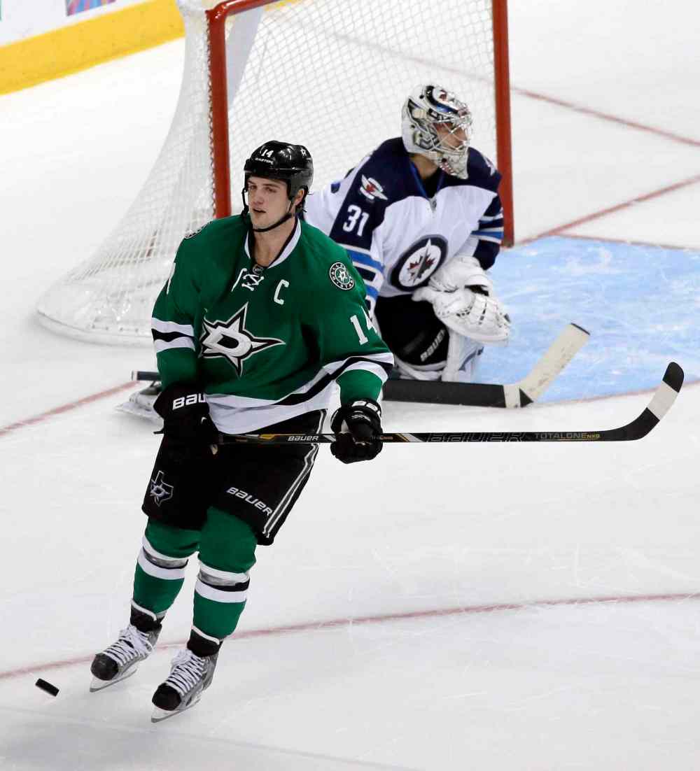 The Associated Press
Dallas Stars captain Jamie Benn skates away after his shootout attempt against Ondrej Pavelec hit the post.
