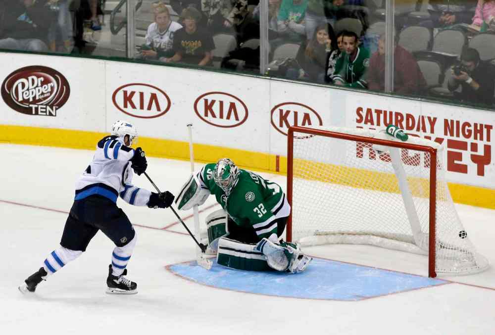 Tony Gutierrez / The Associated Press
Andrew Ladd scores what would end up being the shootout-winning goal against Kari Lehtonen.
