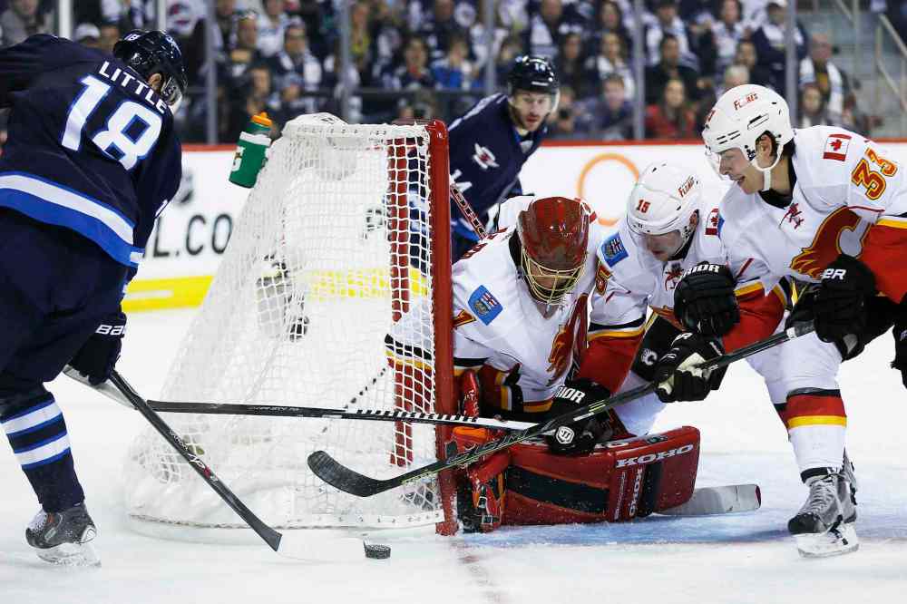JOHN WOODS / WINNIPEG FREE PRESS
Winnipeg forward Bryan Little can't jam the puck past Calgary goaltender Jonas Hiller and teammates Ladislav Smid (15) and Raphael Diaz (33) during the second period.