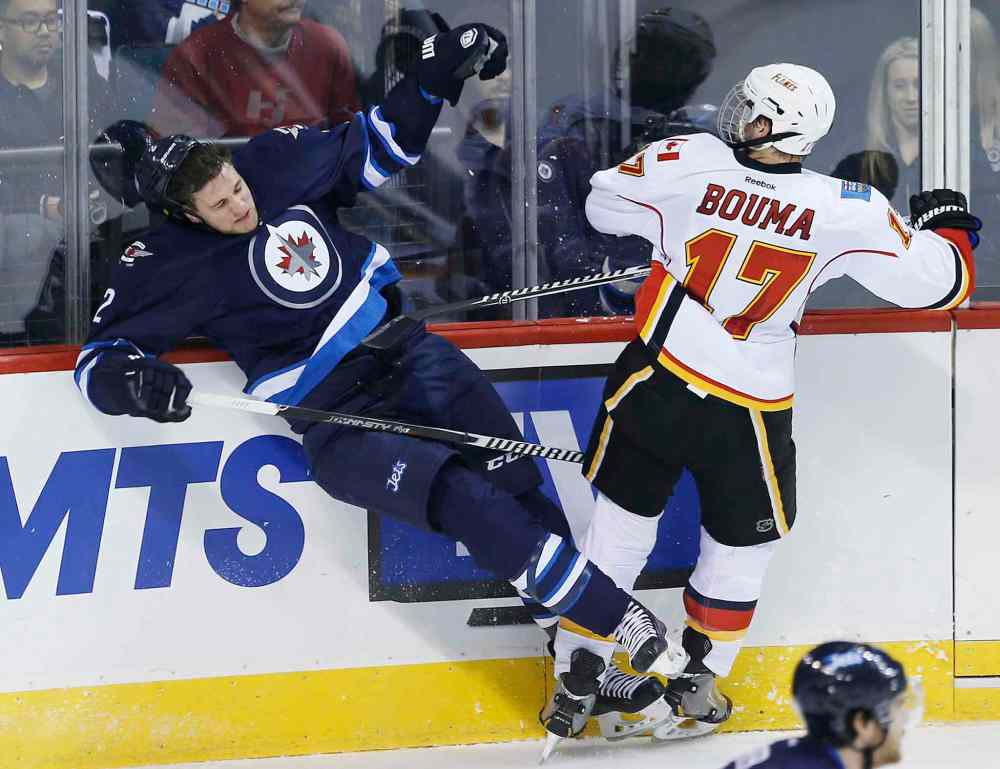 JOHN WOODS / WINNIPEG FREE PRESS
Flames bruiser Lance Bouma takes out Jets defenceman Adam Pardy in the first period.