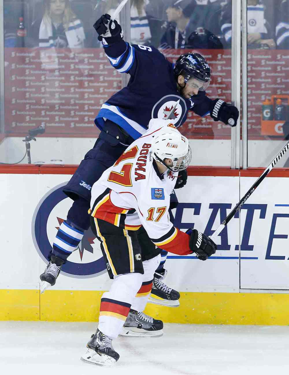 JOHN WOODS / WINNIPEG FREE PRESS
Calgary Flames bruiser Lance Bouma whacks Winnipeg Jets caprtain Andrew Ladd against the boards during the first period.