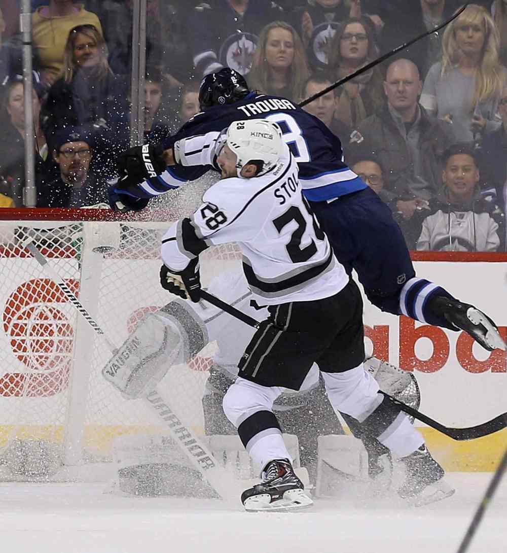 TREVOR HAGAN / THE CANADIAN PRESS
The Kings' Jarret Stoll knocks Jets blue-liner Jacob Trouba into goaltender Jonathan Quick during the first period.