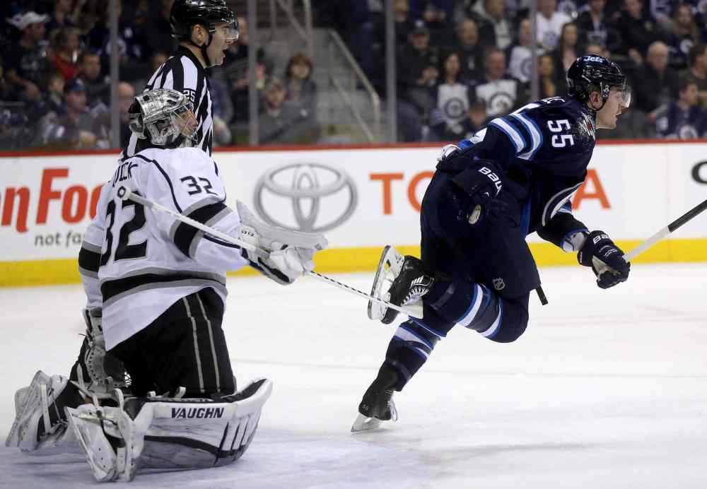 TREVOR HAGAN / THE CANADIAN PRESS
Kings goaltender Jonathan Quick trips Jets centre Mark Scheifele in front of a referee as Scheifele skates away during the second period. There was no penalty called.