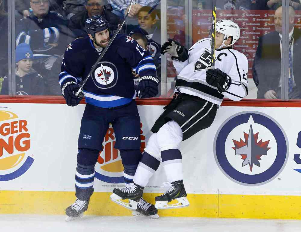 JOHN WOODS / WINNIPEG FREE PRESS
Jets defenceman Jay Harrison checks Kings captain Dustin Brown in the first period.