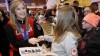 Jennifer Jones greets fans at the Winnipeg airport after arriving home with an Olympic gold medal.