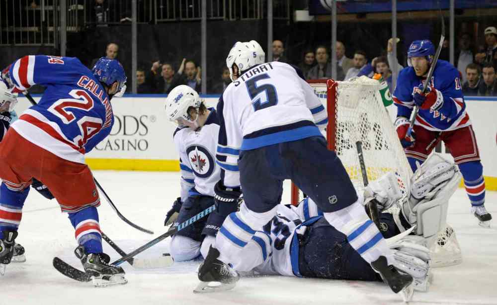 KATHY WILLENS / THE ASSOCIATED PRESS
New York Rangers right-winger Ryan Callahan tries to push the puck into the crease under the knees of the Winnipeg Jets defence in the second period.