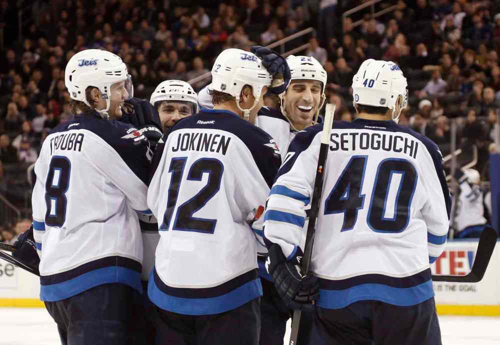 KATHY WILLENS / THE ASSOCIATED PRESS
Winnipeg Jets players celebrate after Olli Jokinen scored a goal in the third period.