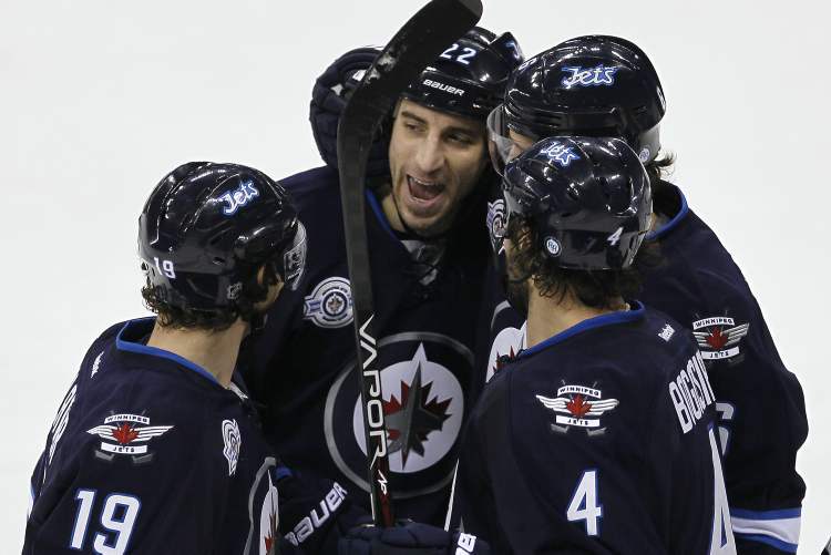 John Woods / Winnipeg Free Press
Winnipeg Jets' Chris Thorburn (22), Zach Bogosian (4), Ron Hainsey (6) and Jim Slater (19) celebrate after Thorburn scores during first-period action Tuesday.