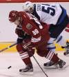 Winnipeg Jets' Mark Scheifele, rear, tries to catch up with Phoenix Coyotes' Mikkel Boedker during third period action at the Jobing.com Arena in Glendale, Arizona. The Coyotes beat the Winnipeg Jets 4-1.   (JOE BRYKSA / WINNIPEG FREE PRESS)