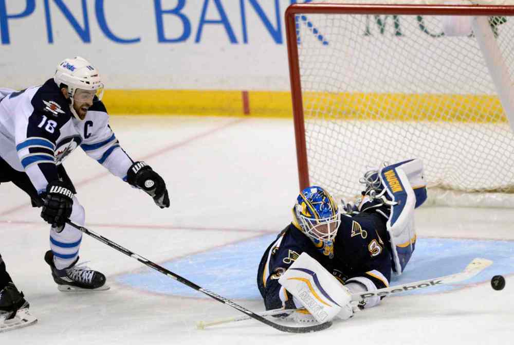 Bill Boyce / The Associated Press
St. Louis Blues' goalie Jake Allen (34) blocks a shot by Winnipeg Jets' Andrew Ladd (16) during the third period.