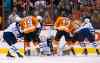 Ondrej Pavelec (centre) stops a shot by the Flyers' Jakub Voracek (second from right) as (from left) Mark Stuart, Scott Hartnell of the Flyers, Dustin Byfuglien and James Wright converge during the first period.