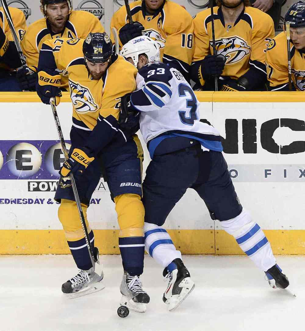 Mark Zaleski / The Associated Press
Nashville Predators left wing Eric Nystrom, left, tries to clear the puck away from Winnipeg Jets defenceman Dustin Byfuglien (33) in the first period of Thursday's game.