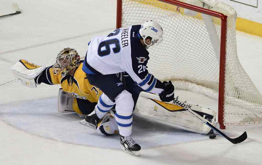 Mark Zaleski / The Associated Press
Nashville Predators goalie Pekka Rinne, left, blocks a shot by Winnipeg Jets right wing Blake Wheeler (26) in the second period of Thursday's game in Nashville.
