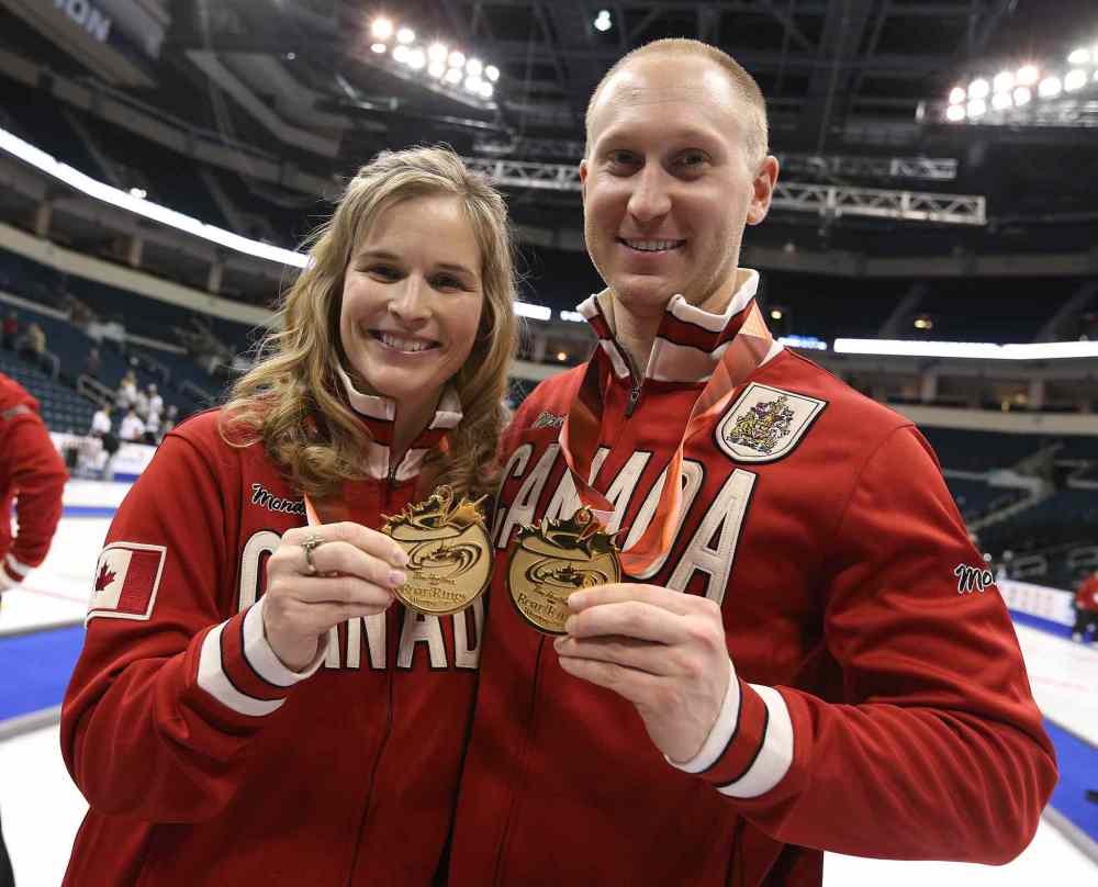Jason Halstead / Winnipeg Free Press
Winnipeg skips Jennifer Jones and Brad Jacobs show off their Team Canada jackets and medals.