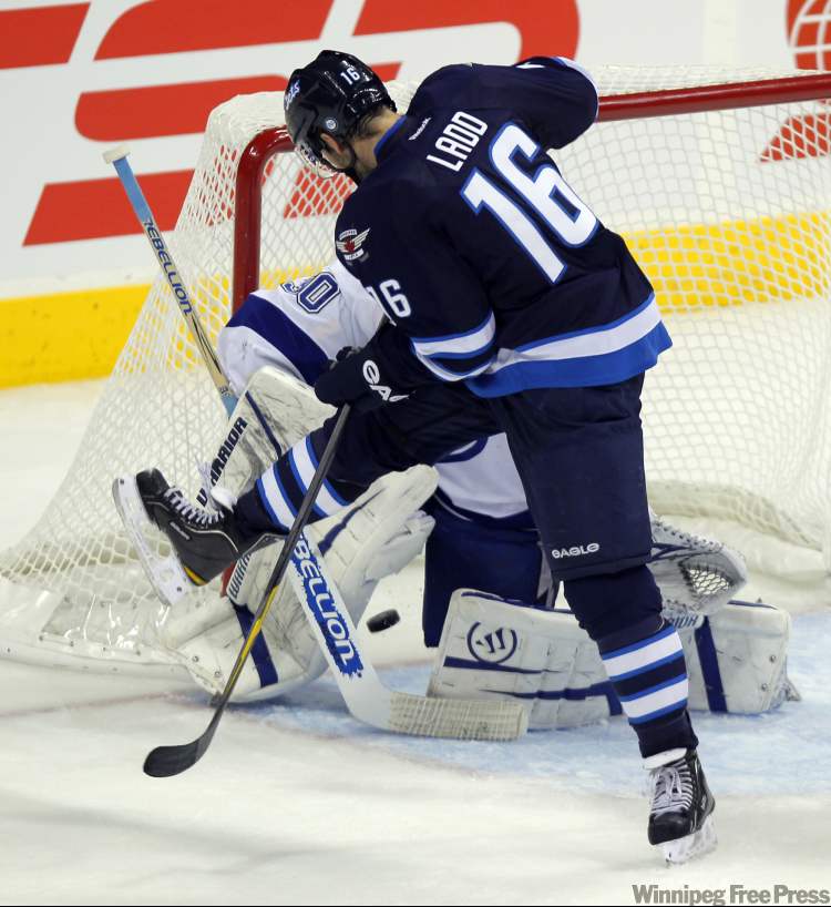Boris Minkevich / Winnipeg Free Press
Andrew Ladd scores the Jets' fourth goal during second-period action Monday.