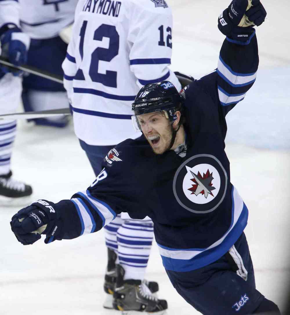 TREVOR HAGAN/WINNIPEG FREE PRESS
Winnipeg Jets' Bryan Little (18) celebrates after Dustin Byfuglien (33) scored to beat the Toronto Maple Leafs' during overtime on Saturday.