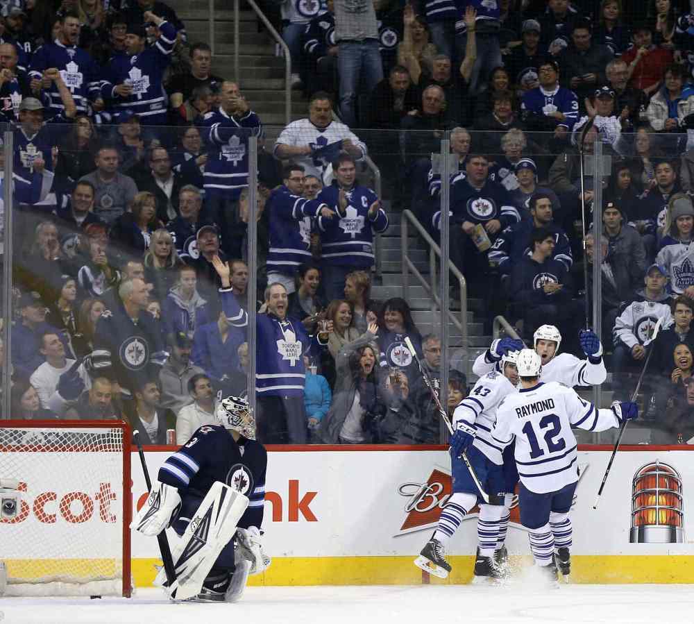TREVOR HAGAN/WINNIPEG FREE PRESS
Winnipeg Jets' goaltender Ondrej Pavelec (31) looks on as Toronto Maple Leafs' Nazem Kadri (43), Mason Raymond (12) and Troy Bodie (40) celebrate Bodie's second-period goal during Saturday's game at Winnipeg's MTS Centre.