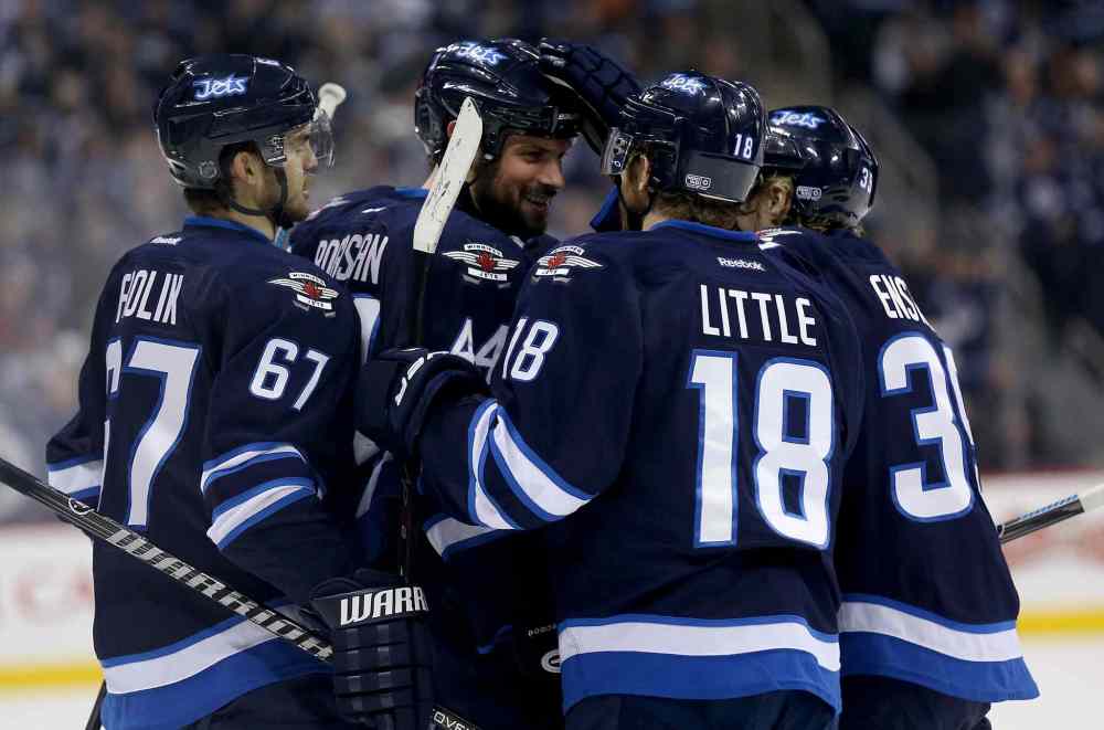 TREVOR HAGAN/WINNIPEG FREE PRESS
Winnipeg Jets' Michael Frolik (67), Zach Bogosian (44), Bryan Little (18) and Tobias Enstrom (39) celebrate after Bogosian scored a second-period goal against the Toronto Maple Leafs.
