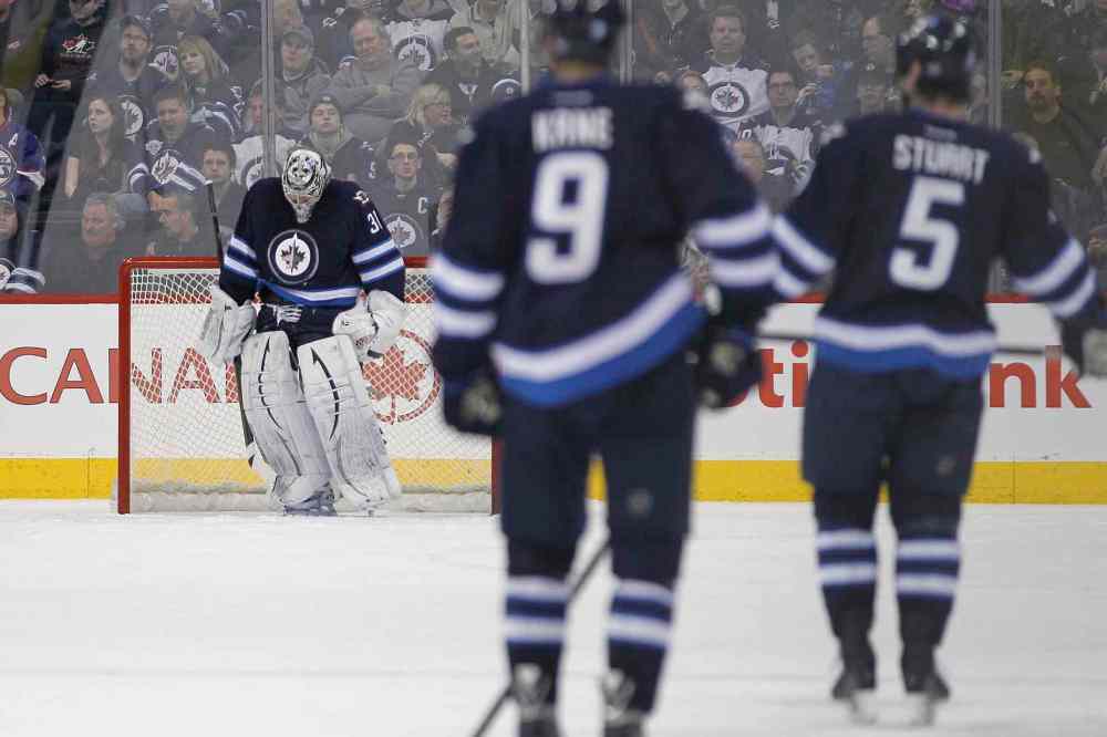 John Woods / Winnipeg Free Press
Winnipeg Jets' goaltender Ondrej Pavelec (31) hangs his head after being scored on by Tampa Bay Lightning's Ondrej Palat (18) during second period NHL action in Winnipeg on Tuesday.