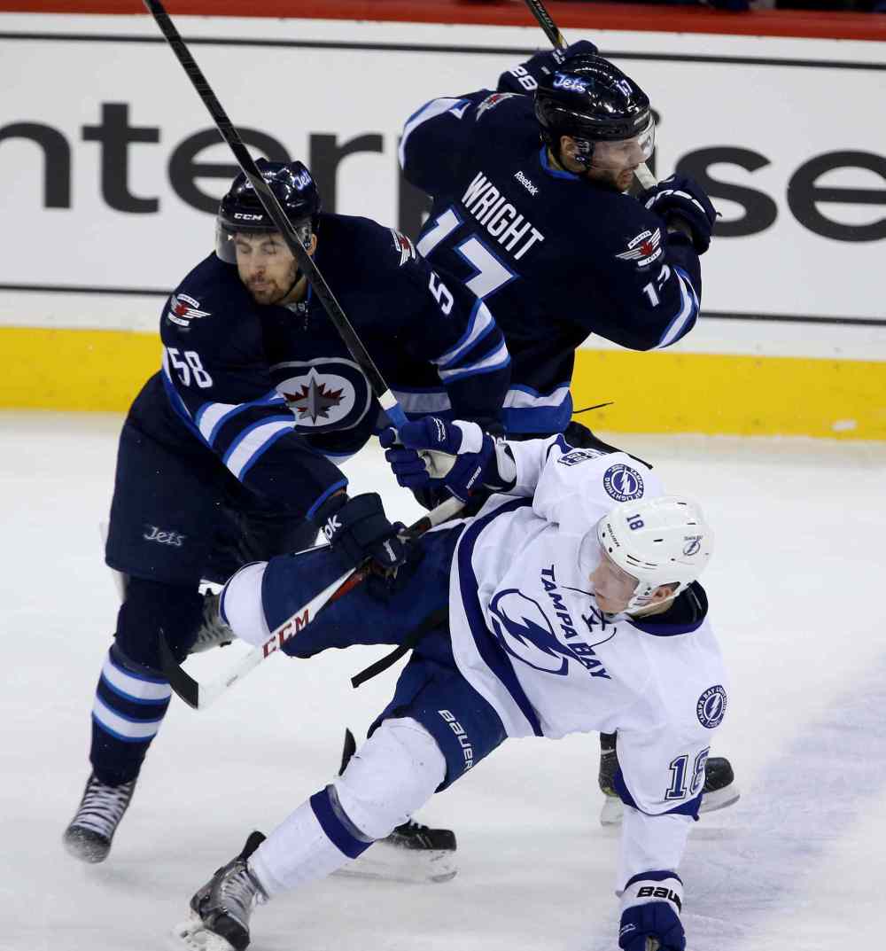 Trevor Hagan / The Canadian Press
Winnipeg Jets' Eric O'Dell (58) and James Wright (17) collide with Tampa Bay Lightning's Ondrej Palat (18) during first period.