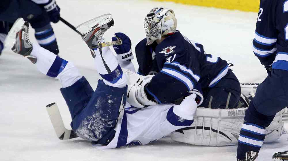 Trevor Hagan / The Canadian Press
Tampa Bay Lightning's Martin St. Louis (26) is smothered by Winnipeg Jets' goaltender Ondrej Pavelec (31) during the first period.