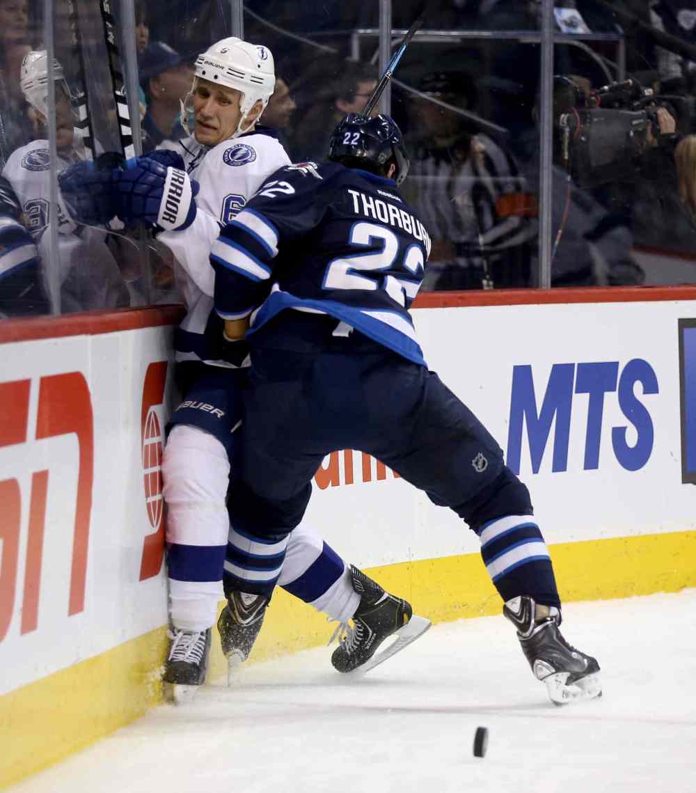 Trevor Hagan / The Canadian Press
Tampa Bay Lightning's Sami Salo (6) gets slammed into the boards by Winnipeg Jets' Chris Thorburn (22) during second period.