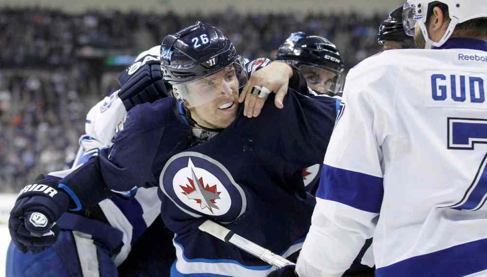 Trevor Hagan / The Canadian Press
Winnipeg Jets' Blake Wheeler (26) is held back from Tampa Bay Lightning's Radko Gudas (7) during second period Tuesday in Winnipeg.