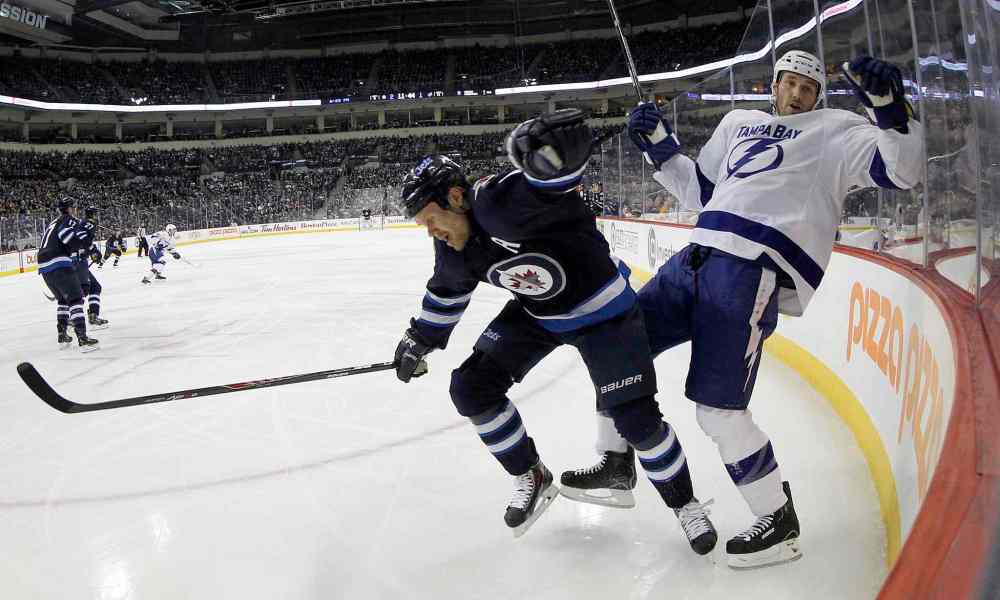 Trevor Hagan / The Canadian Press
Winnipeg Jets' Olli Jokinen (12) hits Tampa Bay Lightning's Eric Brewer (2) during the second period.