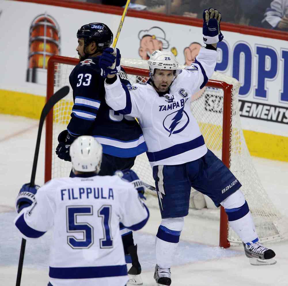 Trevor Hagan / The Canadian Press
Tampa Bay Lightning's Martin St. Louis (26) celebrates what would be the game-winning goal against the Winnipeg Jets' during the third period.