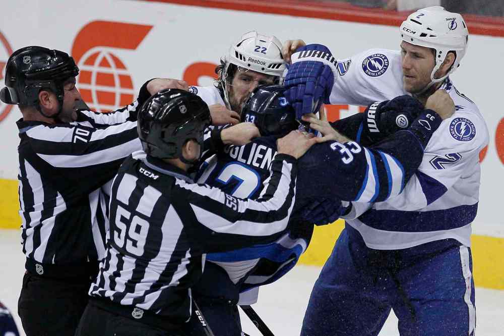 John Woods / WINNIPEG FREE PRESS
Linesmen hold Winnipeg Jets' Dustin Byfuglien (33) back from Tampa Bay Lightning's Jean-Philippe Cole (22) and Eric Brewer (2) during the third period.