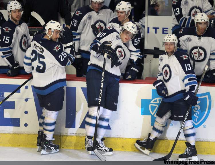 Joe Bryksa / Winnipeg Free Press
Dejected Winnipeg Jets, Brett MacLean, left, Nik Antropov, centre, and Kyle Wellwood after their 4-3 loss to the Chicago Blackhawks.