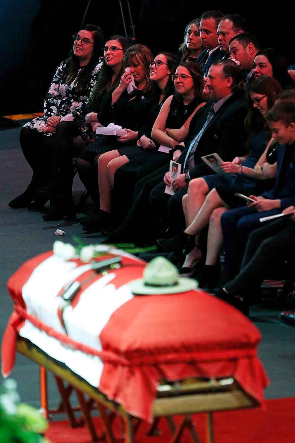 Family members listen to the eulogy. (John Woods / The Canadian Press)