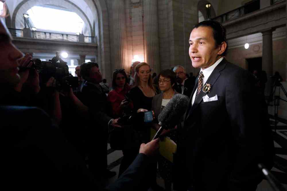 CP
Manitoba NDP MLA Wab Kinew speaks to media after the provincial throne speech at the Manitoba Legislature in Winnipeg, Monday.