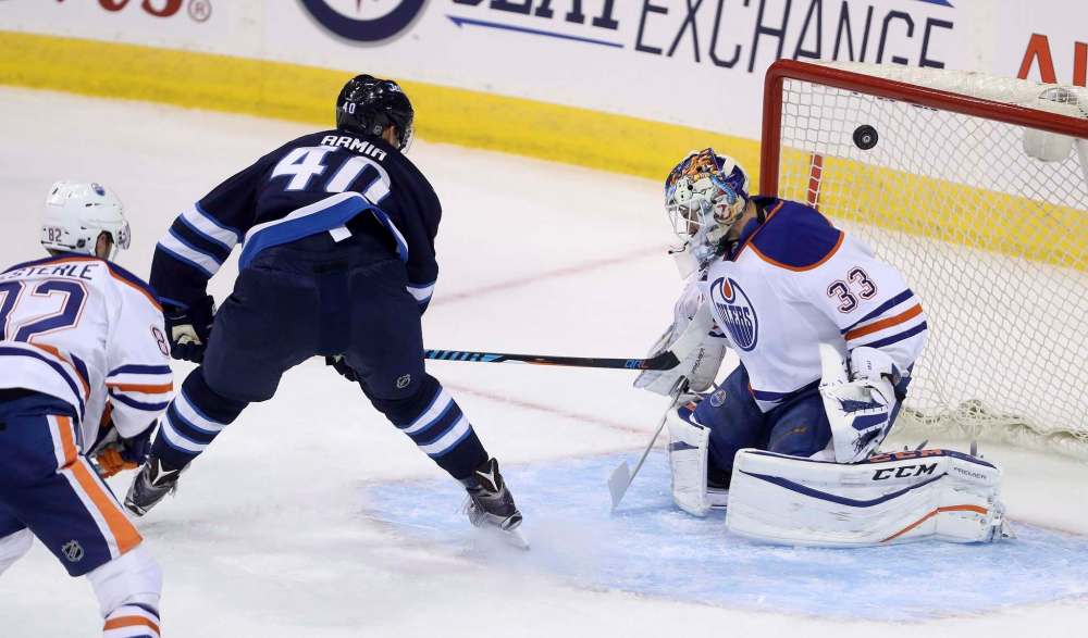 Trevor Hagan / The Canadian Press
Winnipeg Jets' Joel Armia (40) lifts the puck over Edmonton Oilers goaltender Cam Talbot (33) during first period pre-season NHL hockey in Winnipeg, Friday.
