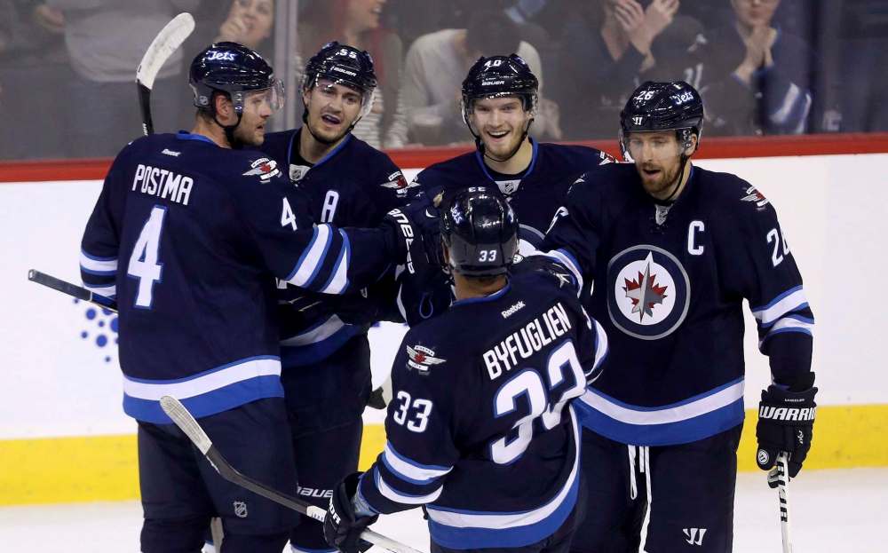 Trevor Hagan / The Canadian Press
Winnipeg Jets' Paul Postma (4), Mark Scheifele (55), Joel Armia (40), Dustin Byfuglien (33) and Blake Wheeler (26) celebrate after Armia scored against the Edmonton Oilers during first period pre-season NHL hockey in Winnipeg, Friday.