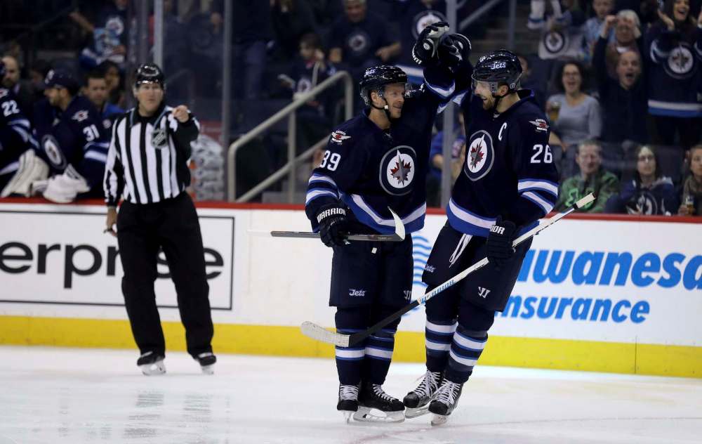 Trevor Hagan / The Canadian Press
Winnipeg Jets' Toby Enstrom (39) and Blake Wheeler (26) celebrate after Enstrom scored against the Edmonton Oilers during second period pre-season NHL hockey in Winnipeg, Friday.