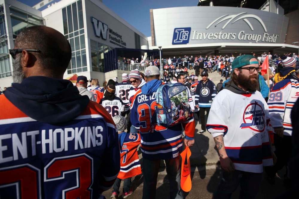 RUTH BONNEVILLE / WINNIPEG FREE PRESS
Fans young and old in orange and white make their way to entrance to stadium before gates open Saturday.