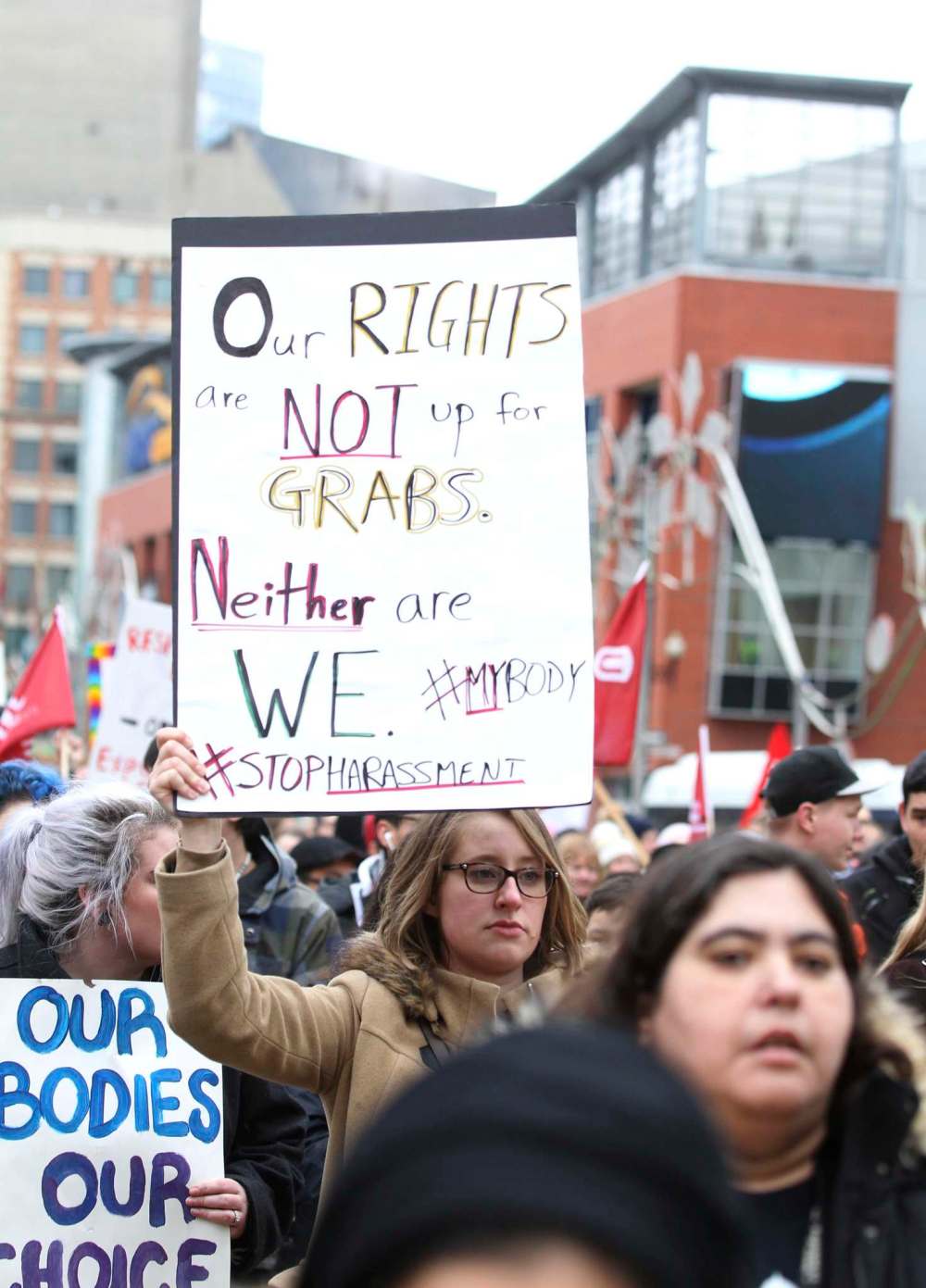 A young woman holds a sign as she walks with hundreds of others down Portage Ave. Saturday during the Women's Day March as hundreds of sister marches are being held around the world including Washington.