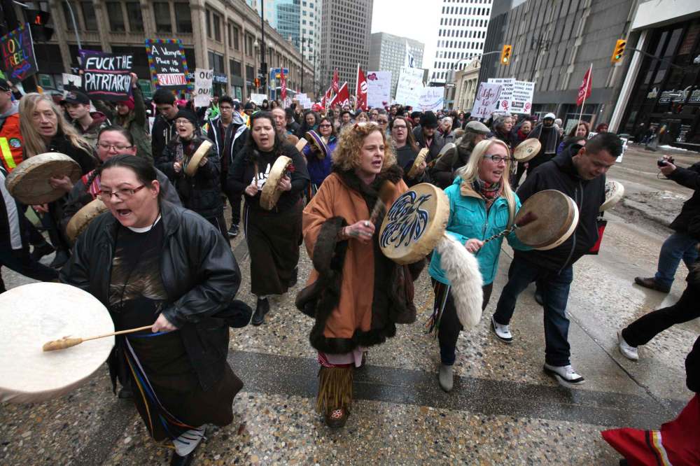 The Buffalo Gals Drumming Group rally in front of thousands of people marching along Portage Ave. Saturday.