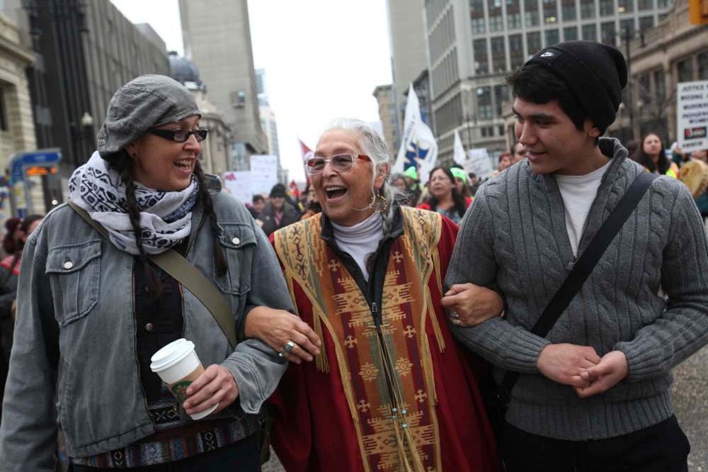 Elder Mae Louise Campbell is all smiles as she heads up the Women's Day March with thousands of supporters along Portage Ave. Saturday.