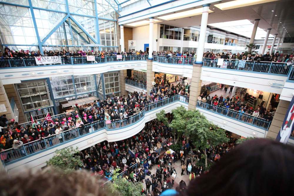 Hundreds of people gather around centre court at Portage Place Mall to celebrate Women's Day rally and march on Saturday.