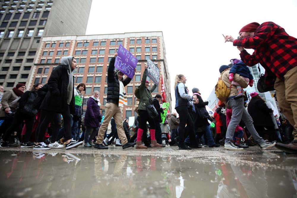 Thousands braved soggy conditions during their march along Portage Ave. Saturday during the Women's Day March.