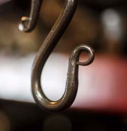A hook hangs in the forge.