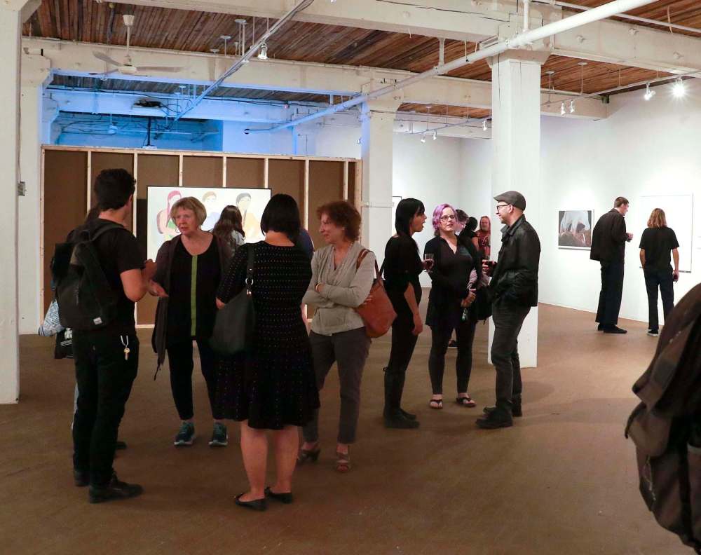 Attendees view works by 19 artists at the opening of the Floe Edge: Contemporary Art and Collaborations from Nunavut . (Photo: Urban Shaman)
