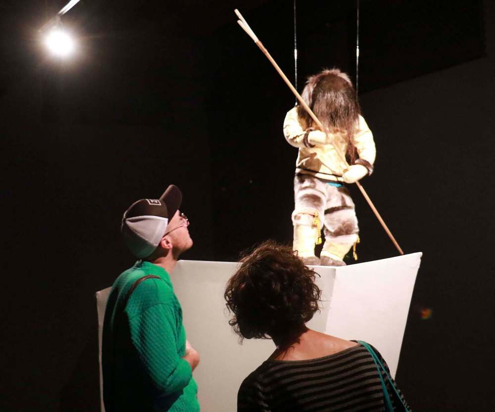 Attendees check out artist Mona Nestor’s realistic, traditonally-clad figure, Hunter with Kakivak. (Photo: Urban Shaman)