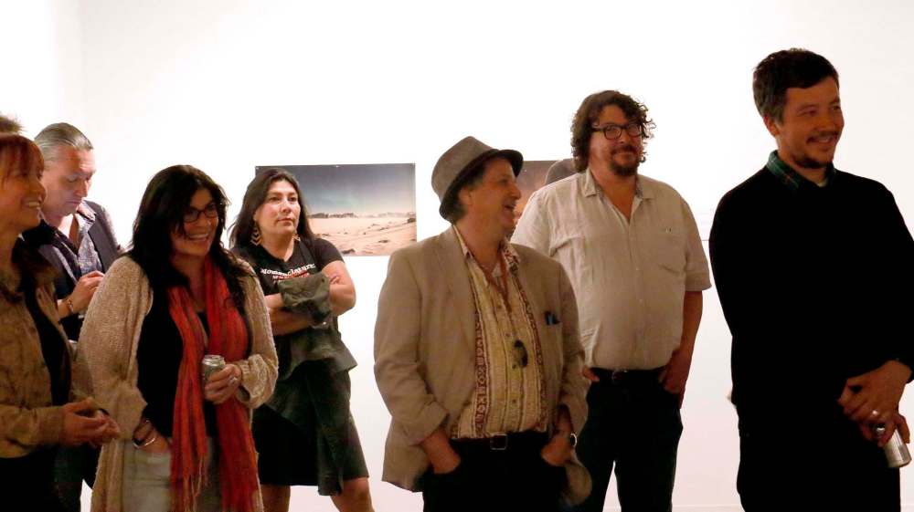 Opening night gallery-goers listen to remarks from Stefan St-Laurent, artistic director, at the opening. (Photo: Urban Shaman)
