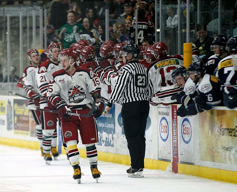 PHIL HOSSACK / WINNIPEG FREE PRESS - Virden Oil Capitals #15 leads his line past the bench after scoring the tying goal against the Steinbach Pistons in the second period at the Virden Tundra Oil Gas Place Thursday. Melissa Martin story.- April 12, 2018
